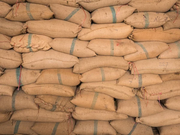 Old hemp sacks stacked in a row. — Stock Photo, Image