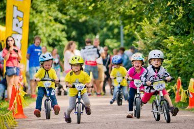 Russia. Moscow. Vorontsovsky Park on the 21st of August. STRIDER CUB 2016. Racing on the balance bike clipart