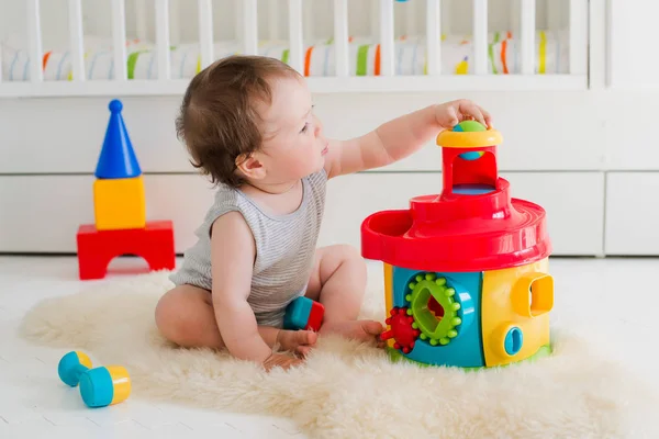 Baby spielt im Kinderzimmer mit Lernspielzeug — Stockfoto