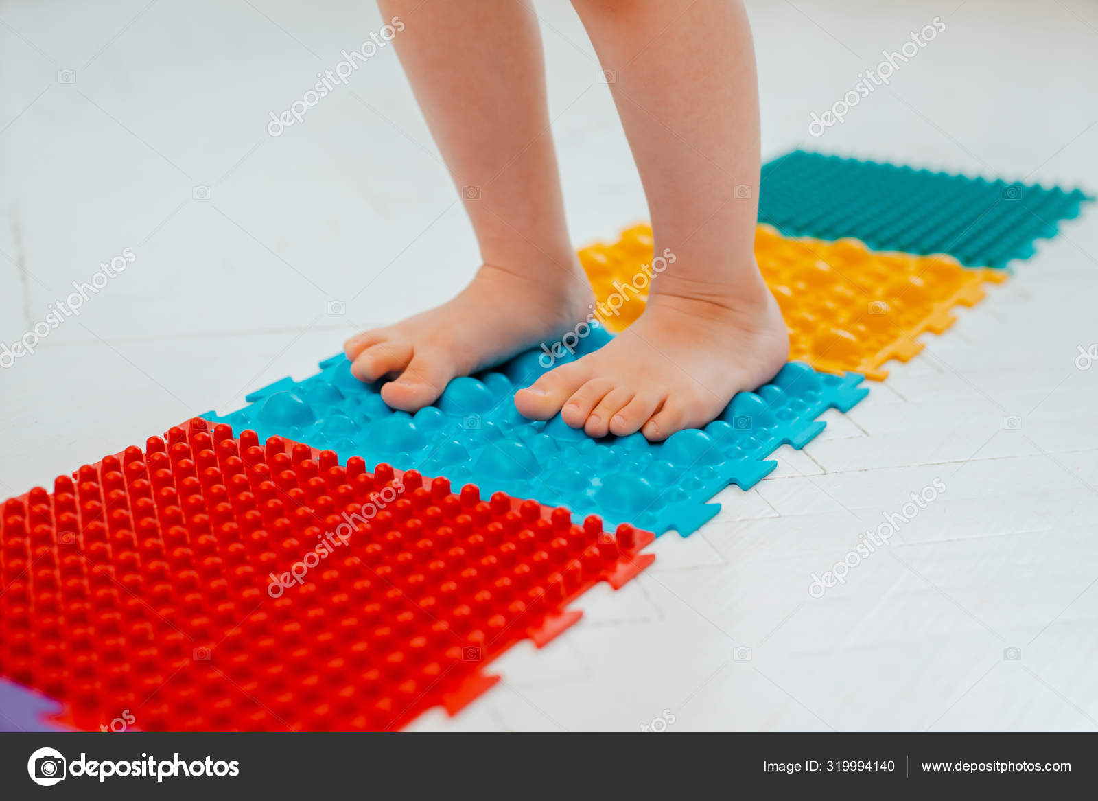 Toddler On Baby Foot Massage Mat Exercises For Legs On Orthopedic