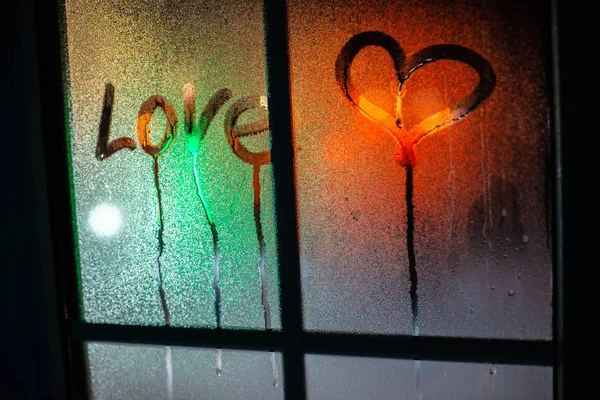Heart and love inscription on the fogged glass against — Stock Photo, Image
