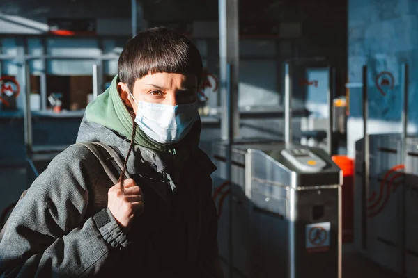 A man in a medical protective mask on public transport. Concept of human use of protective face masks against viral infection in the context of the coronavirus crisis in 2020, cavid-19, quarantine