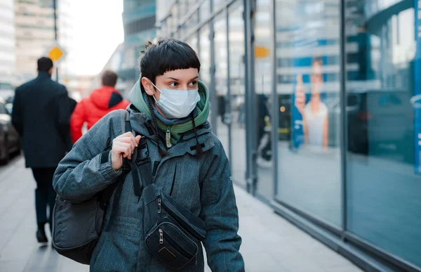 Tourist mask on background of city\'s metropolis. Concept for people to use protective face masks against viral infection in the Corona virus crisis of 2020, cavid-19, quarantine