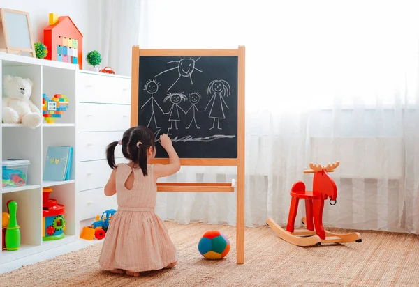 Girl Stands Children Room Blackboard Draws Family Chalk Concept Family — Stock Photo, Image