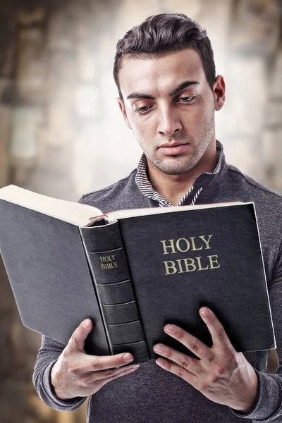 Reading and holding Holy Bible — Stock Photo, Image