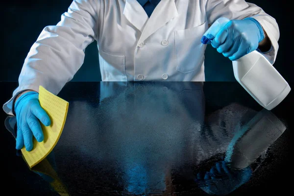 Person Dressed White Uniform Spraying Table Virus Solution Stock Photo