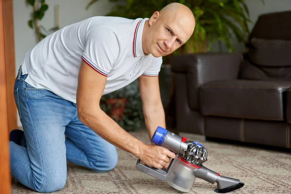 Homem com aspirador de pó em casa.tarefas domésticas e conceito de rotina . — Fotografia de Stock