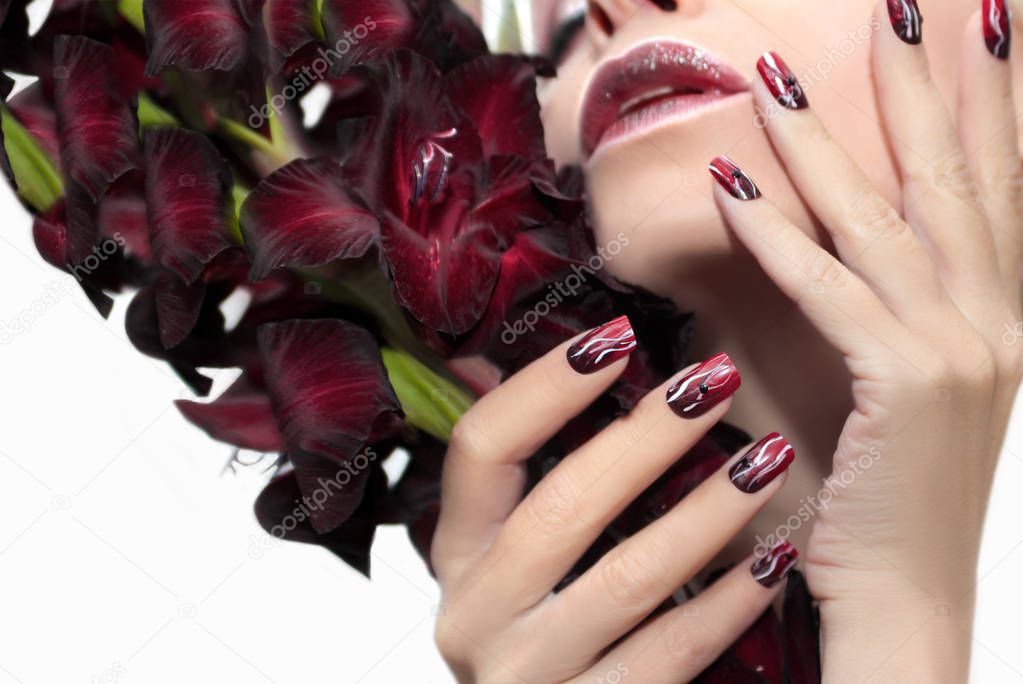Burgundy manicure with gladiolus.