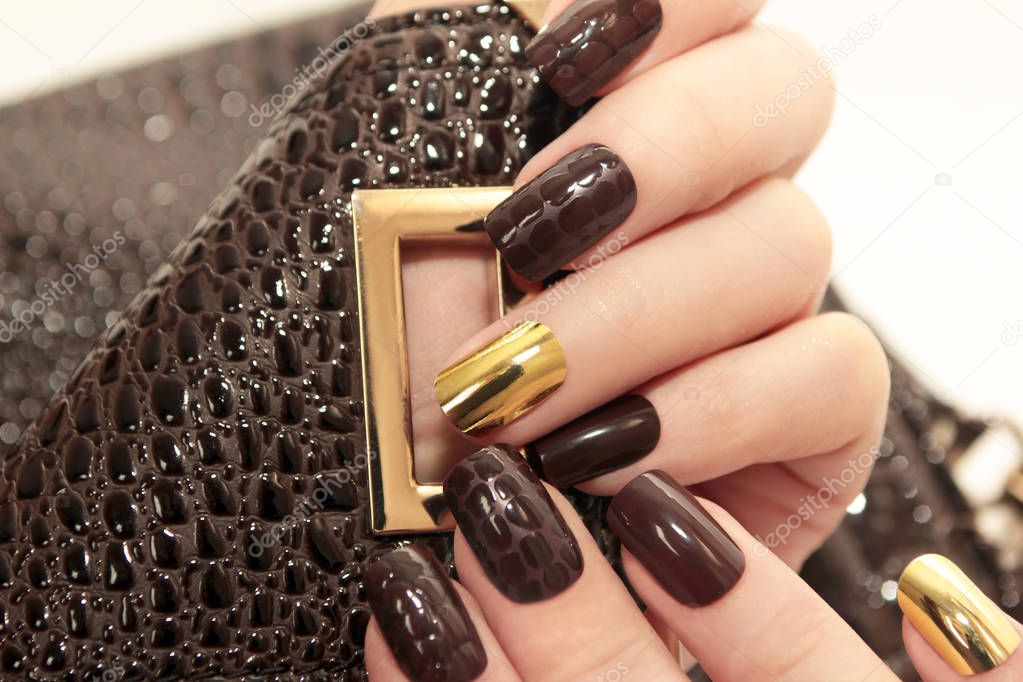 Glamorous luxurious brown crocodile manicure.