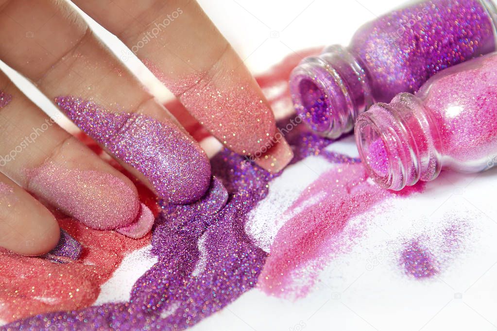 Demonstration of multicolored sequins that use for body, makeup and nail design close up on white background.