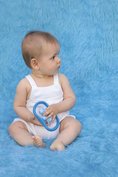 Small Infant Sits Blue Background Toy His Hands Expresses Emotions — 스톡 사진