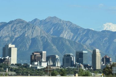 SALT LAKE CITY, UT - AUG 30: Downtown Salt Lake City in Utah, as seen on Aug 30, 2017. The city is bordered by the buoyant waters of the Great Salt Lake and the snow-capped peaks of the Wasatch Range. clipart