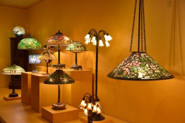 Kışları PARK, FL - 29 Kasım 2019 'da Florida' daki Charles Hosmer Morse Amerikan Sanat Müzesi 'nde Louis Comfort Tiffany tarafından görülen lambalar ve ışıklandırma.