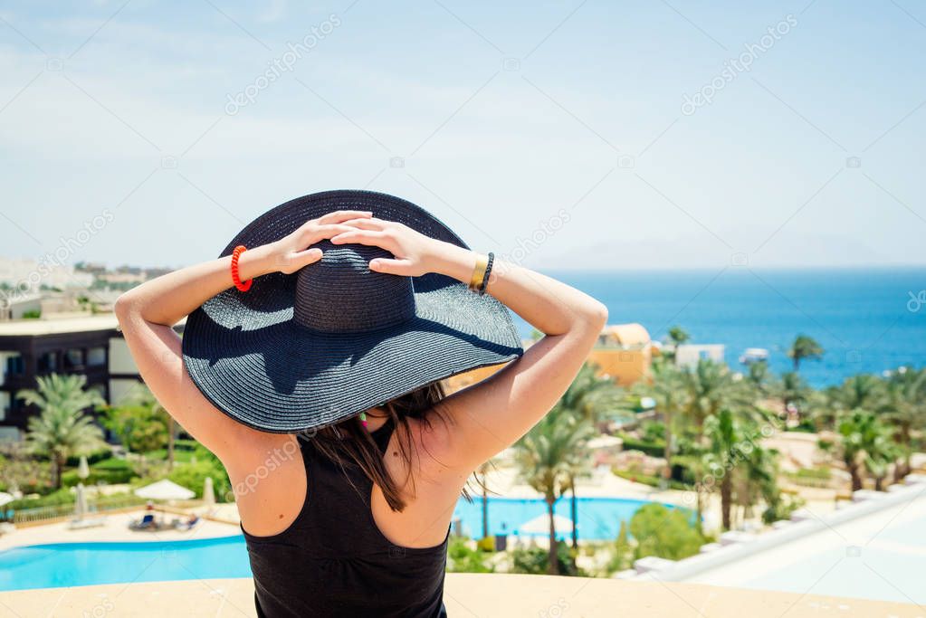 woman in black hat at the resort