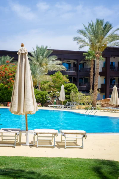 Swimming pool with umbrella — Stock Photo, Image