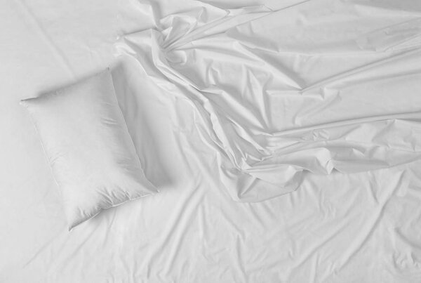 close up of a white bedding sheet 