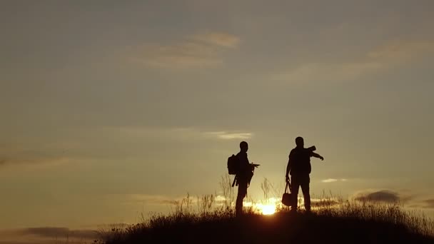 Menschen Touristen. Menschen Gruppe von Touristen zu Fuß auf der Spitze Natur einer Reise Sonnenuntergang Silhouette Berg. Langsames Video Touristengruppe geht — Stockvideo
