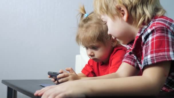 Children teamwork watch online video cartoons on a smartphone ...