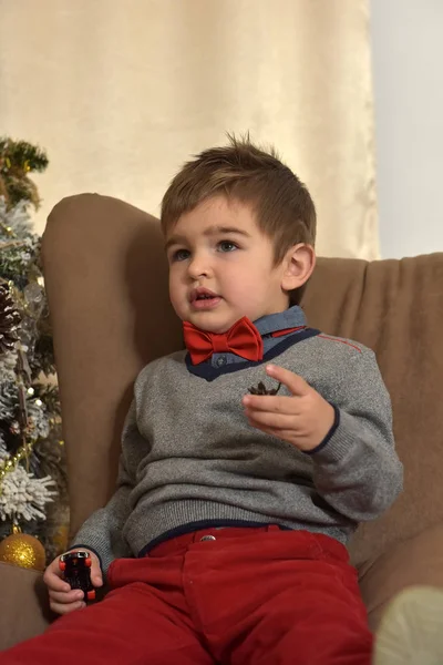 A boy in red pants and a bow tie — Stock Photo, Image