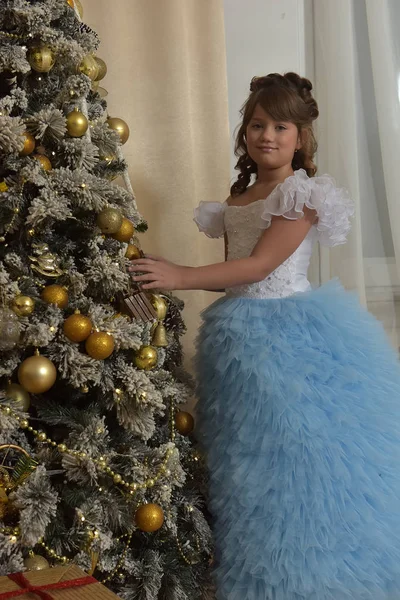 圣诞时节 身穿蓝色雅致礼服的白衣公主来到圣诞树旁 — 图库照片