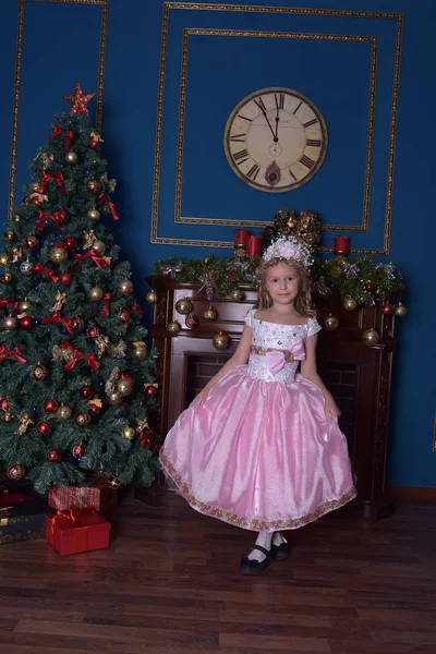 Flicka i vitt med en rosa klänning i jul — Stockfoto
