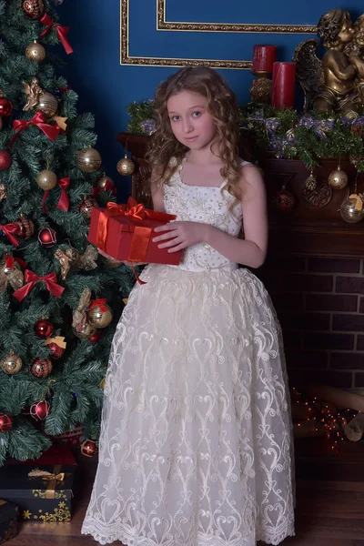 Ragazza in un vestito bianco intelligente a un albero di Natale — Foto Stock