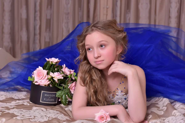 Young princess in a blue evening dress with roses — Stock Photo, Image