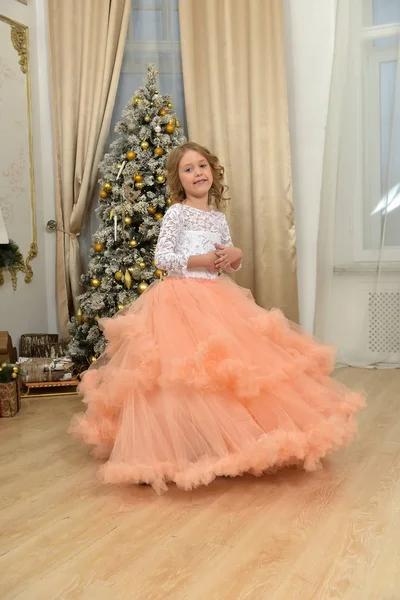 A young girl in a chic white with peach dress — Stock Photo, Image