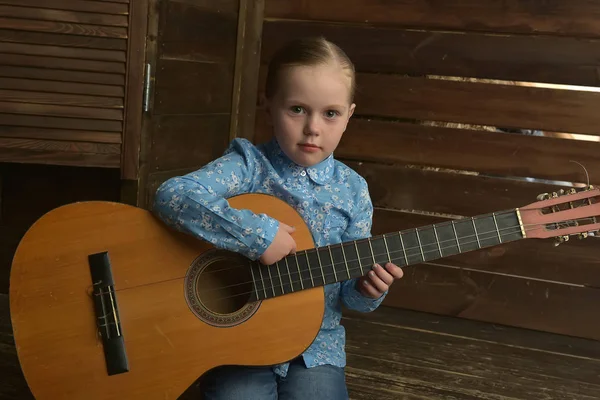 Little girl with a guitar — Stock Photo, Image