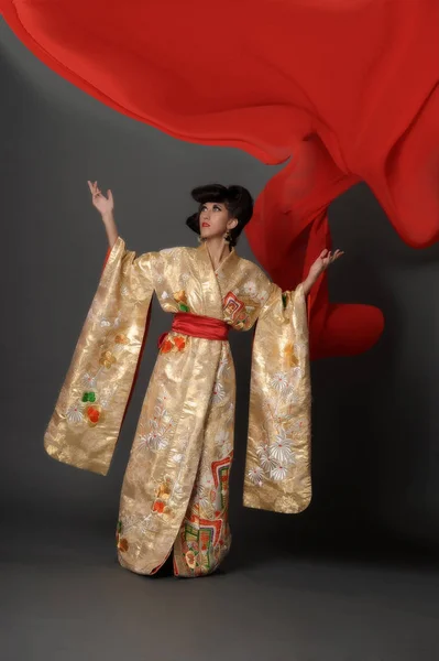 Woman in golden kimano — Stock Photo, Image