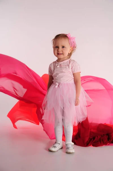 Niña en un vestido rosa en el estudio —  Fotos de Stock