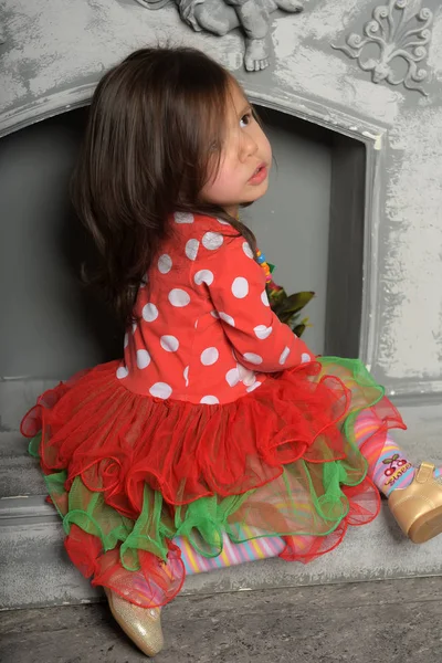 Κορίτσι παιδί, σε ένα κόκκινο με ένα πράσινο φόρεμα με ένα μπουκέτο από κόκκινο fl — Φωτογραφία Αρχείου