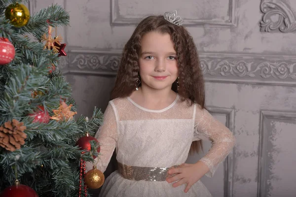 Girl in ivory festive dress in christmas with a crown — Stock Photo, Image