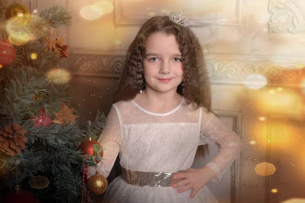 Girl in ivory festive dress in christmas with a crown — Stock Photo, Image