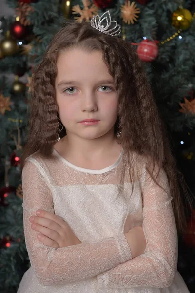 Girl in ivory festive dress in christmas with a crown — Stock Photo, Image