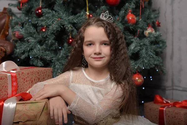 Girl in ivory festive dress in christmas with a crown — 스톡 사진