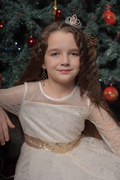 Girl in ivory festive dress in christmas with a crown — Stock Photo, Image