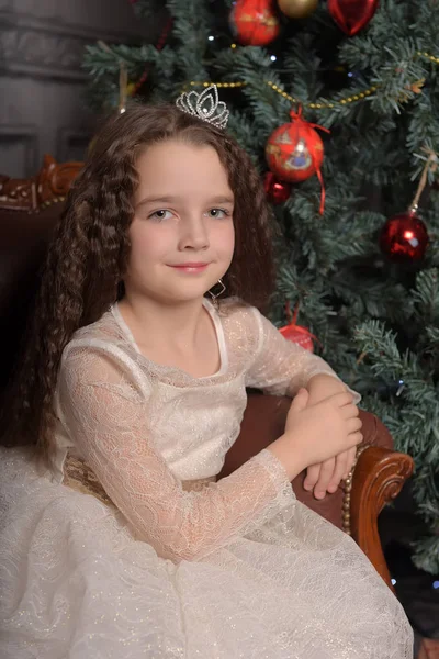 Girl in ivory festive dress in christmas with a crown — Stock Photo, Image