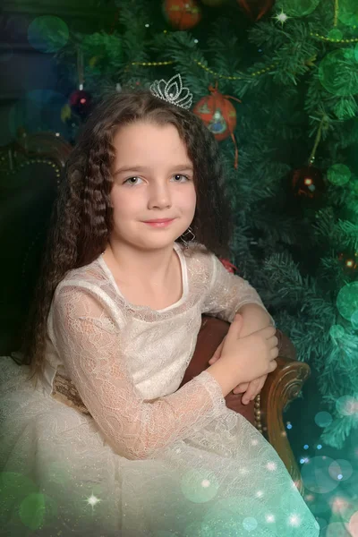 Girl in ivory festive dress in christmas with a crown — Stock Photo, Image