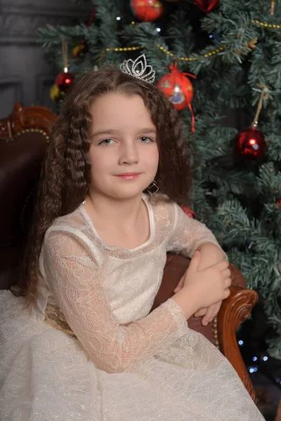 Girl in ivory festive dress in christmas with a crown — 스톡 사진