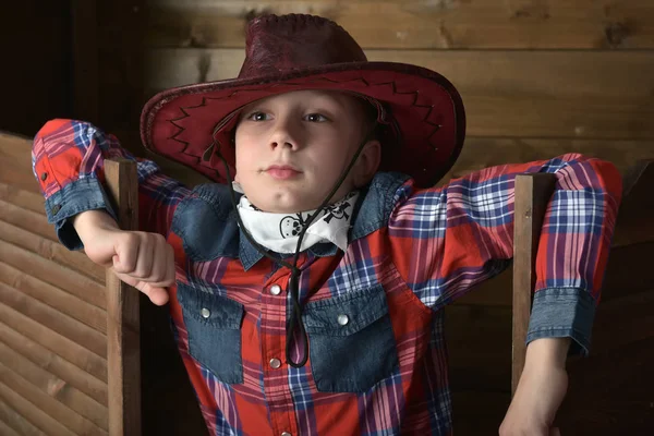 Boy in a plaid shirt and a  hat — Stock Photo, Image