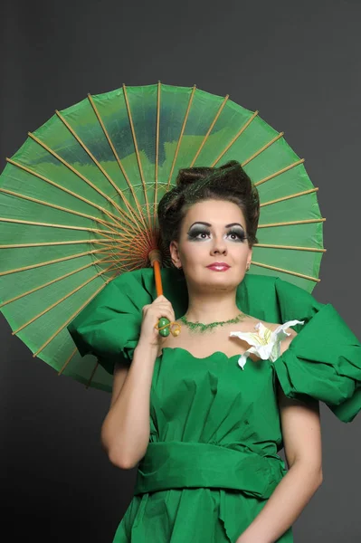 Girl in green with stylish hair styling and creative make-up wit — 스톡 사진