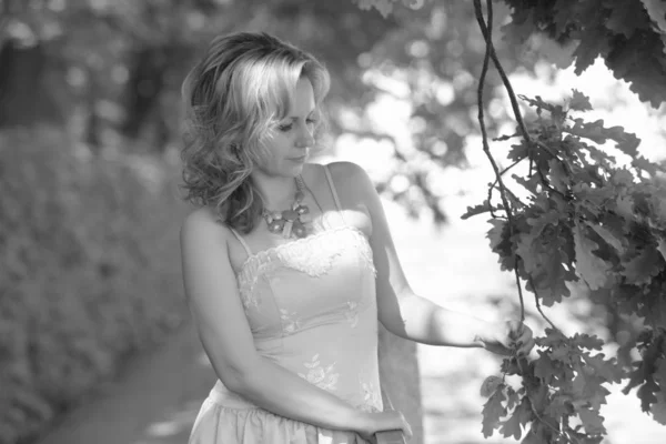 Блондинка в літній сукні в парку — стокове фото