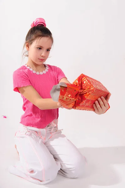 Girl in pink in the studio with a huge candy — 스톡 사진