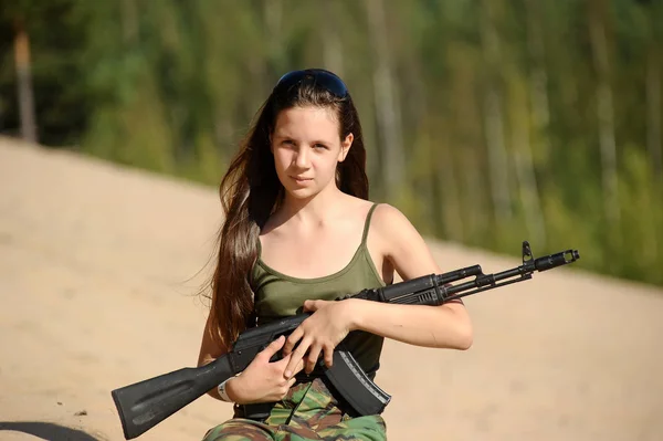 Meisje in de zomer op een zandige helling met een pistool — Stockfoto