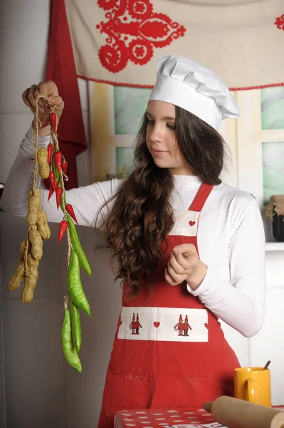 Beautiful brunette in a cook hat — Stock Photo, Image