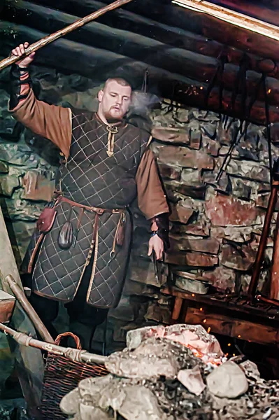 A blacksmith in a medieval forge, Historical reconstruction of t — Stock Photo, Image