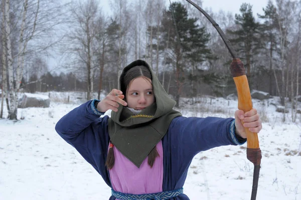 Una chica dispara en el invierno de un arco en el festival de mediev —  Fotos de Stock