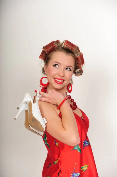 Girl in curlers with shoes, — Stock Photo, Image