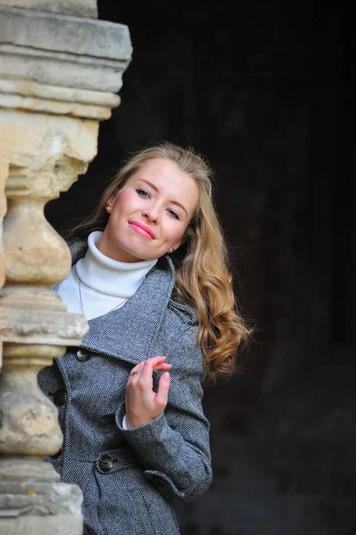 Beautiful girl in a gray coat — Stock Photo, Image